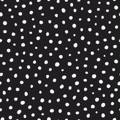 Randomly placed polka dots, hand drawn spots seamless vector pattern. Scattered big and small circles, points in various sizes. Monochrome retro background. Decorative black and white design tiles.
