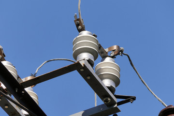 Clos up view of isolators with high voltage wires with blue sky.