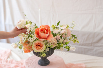 Woman hands touching  a bouquet of flowers.