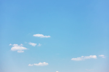 Pastel blue sky with white clouds