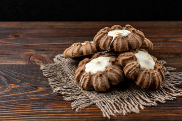 Fototapeta na wymiar Chocolate shortbread cookies on dark wooden background.