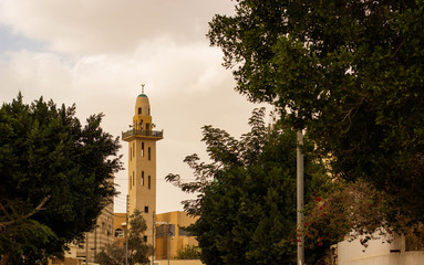 Fototapeta premium common Eastern city street with Minaret tower