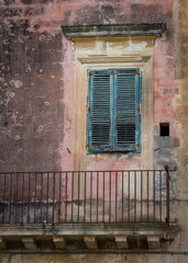Fototapeta na wymiar Old rustic door on a balcony in Italy