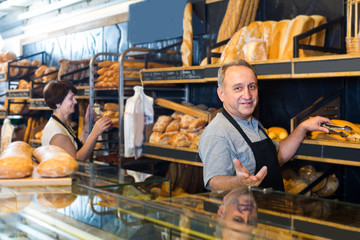 staff offering fresh baguettes