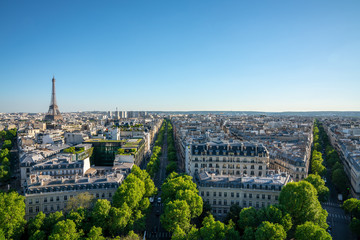 Paris street with view on the famous paris eiffel tower on a sunny day with some sunshine