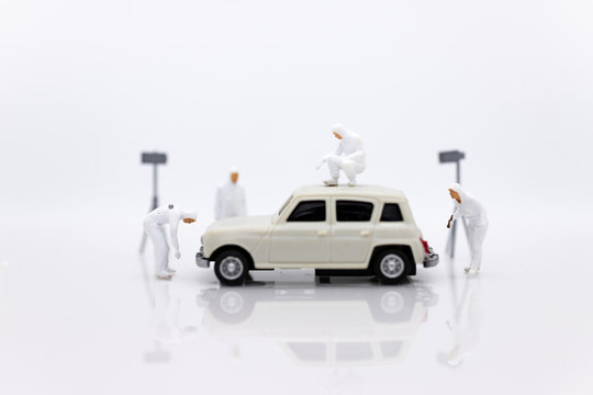Miniature people : Workers are repairing car. Image use for engine maintenance, car care.