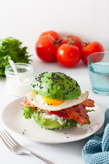 keto paleo diet avocado breakfast burger with bacon, egg, tomato