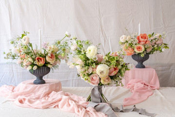Still life with  beautiful bouquets of flowers and candles