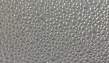 Drops of condensate on the surface of a plastic bottle, close-up