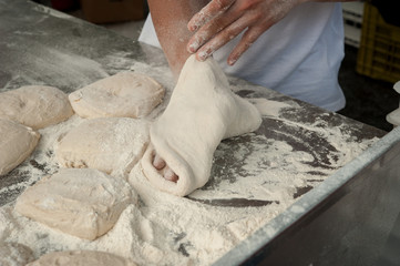 Preparing pizza Margherita dough on a  countertop. 