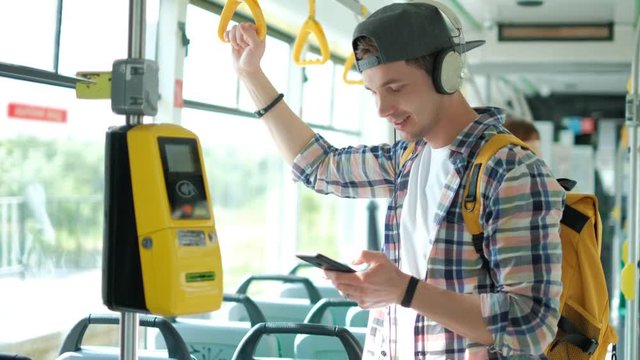 Tourist on the train uses a mobile phone to call or send a message or view a map or mobile application.