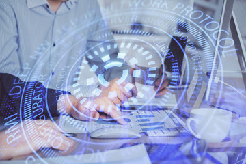 Double exposure of technology hologram with man working on computer background. Concept of big data.