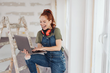 frau auf der baustelle surft im internet
