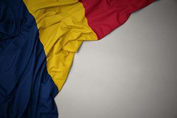 waving national flag of chad on a gray background.