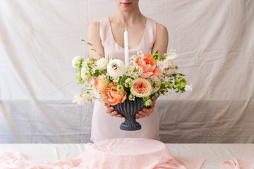 Obraz na płótnie Canvas Woman holding vase full of flowers.