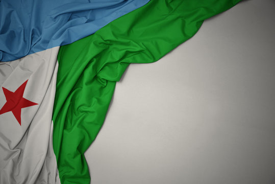 waving national flag of djibouti on a gray background.