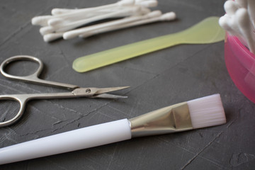 set for cosmetic skin care, brush, cotton buds on a dark background