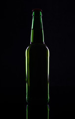 Green beer bottle, isolated on black background