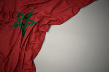 waving national flag of morocco on a gray background. - obrazy, fototapety, plakaty