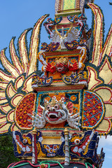 Bade cremation tower with traditional balinese sculptures of demons and flowers on central street in Ubud, Island Bali, Indonesia . Prepared for an upcoming cremation ceremony