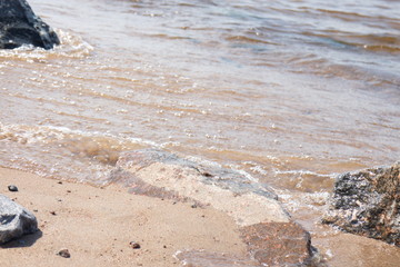 coastal wave with foam on a sunny day