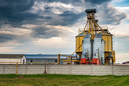 agro-processing plant for processing and silos for drying cleaning and storage of agricultural products, flour, cereals and grain with beautiful clouds
