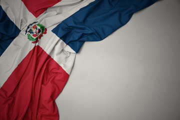 waving national flag of dominican republic on a gray background. - obrazy, fototapety, plakaty