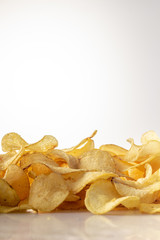 golden brown potato chips on a white background.