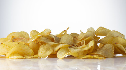 golden brown potato chips on a white background.