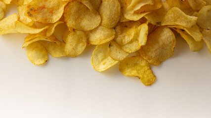 golden brown potato chips on a white background.