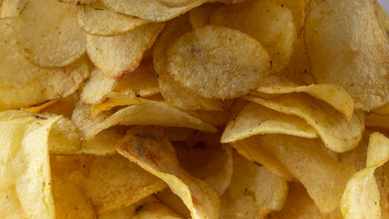 Texture fried golden brown potato chips, close-up