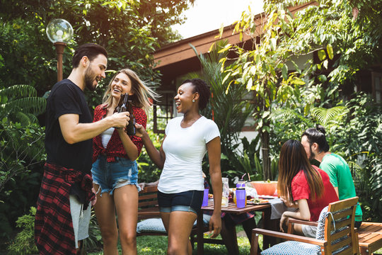 Happy Friends Fun At In The Backyard - Young People Camping At Summer Outdoor Party And Holidays  - Youth Friendship Concept With Guys And Girls Drinking Wine At Barbecue Party