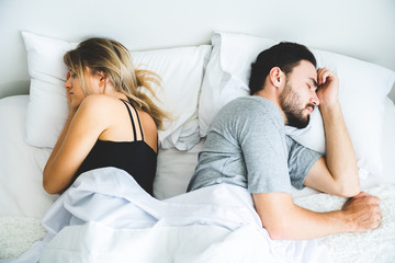Sad lovers after quarrel  ignoring avoiding sex in bed, frustrated man and woman not talking feeling offended or stubborn, unhappy married couple and sexual problems concept.