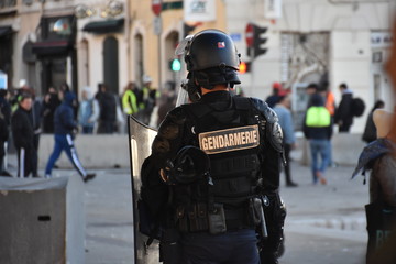 Helmeted gendarme photographed from behind during a protest