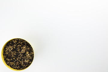 Cat grass seeds sown in yellow pot  in bottom left on white background