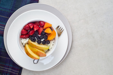 Sliced strawberry, apricot, apple and black mulberry with curd and sour cream