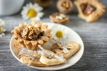 Obraz na płótnie Canvas Homemade baking. Shortcake dough baskets with walnuts and condensed milk.