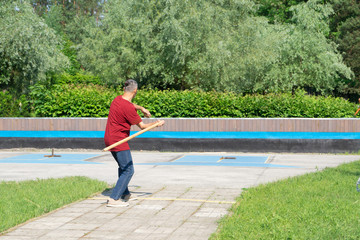 Man playing gorodki in the park