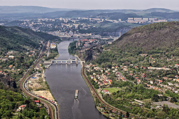 Fototapeta na wymiar Labe river with the cargo boat by flood-gate of Usti-nad-Labem city