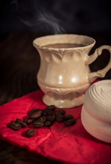Vintage cup of coffee with homemade zephyr, pieces of brown sugar and coffee beans 
