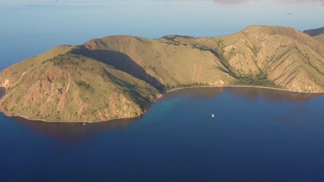 Soft afternoon light illuminates the scenic island of Gili Banta, just outside of Komodo National Park, Indonesia. This tropical area is known for its marine biodiversity.
