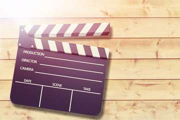 Film clap board on wooden desk background