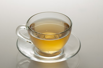 cup of herbal tea with chamomile flowers on a white table