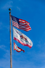 THe US Stars and Stripes, old glory and the California Republic flags waving