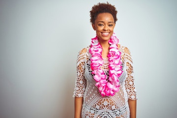 Young african american woman with afro hair wearing flower hawaiian lei over isolated background with a happy and cool smile on face. Lucky person. © Krakenimages.com