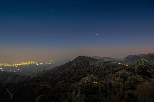 sunset at Doi Ang Khang, Mountain view evening of top hill around with soft fog and yellow sun light in the sky background, Monzone Camping Zone, Doi Angkhang, Chiang Mai, Thailand.