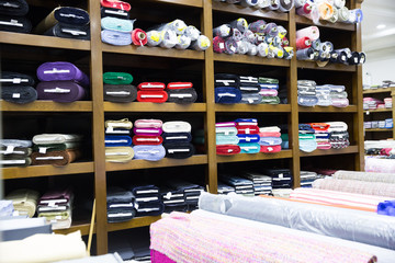 Naklejka na ściany i meble Rolls of fabric and textiles in shop