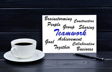 Teamwork word on notebook on a wooden table