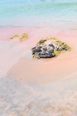 Stones and colorful sand on a tropical beach. Copy space.