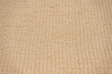 close-up background of Yellow sand with traces of machinery